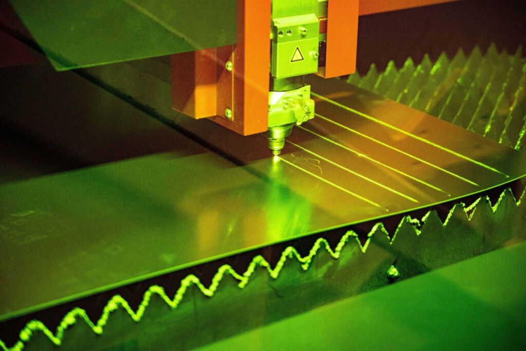 High-powered laser machine cutting zigzag pattern on metal