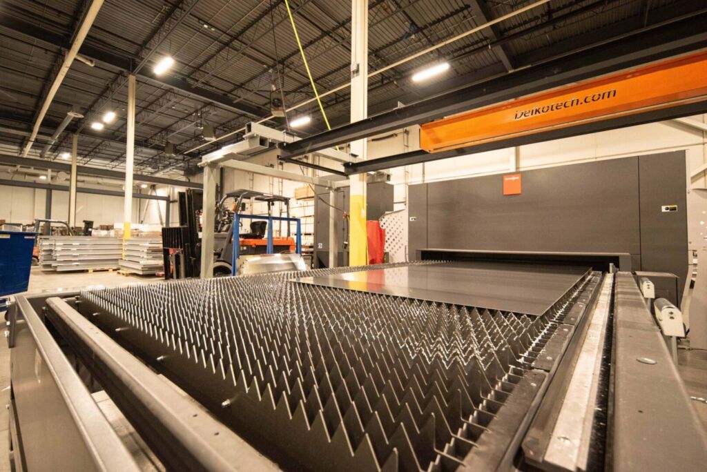 Wide shot of laser cutting bed inside aluminum factory