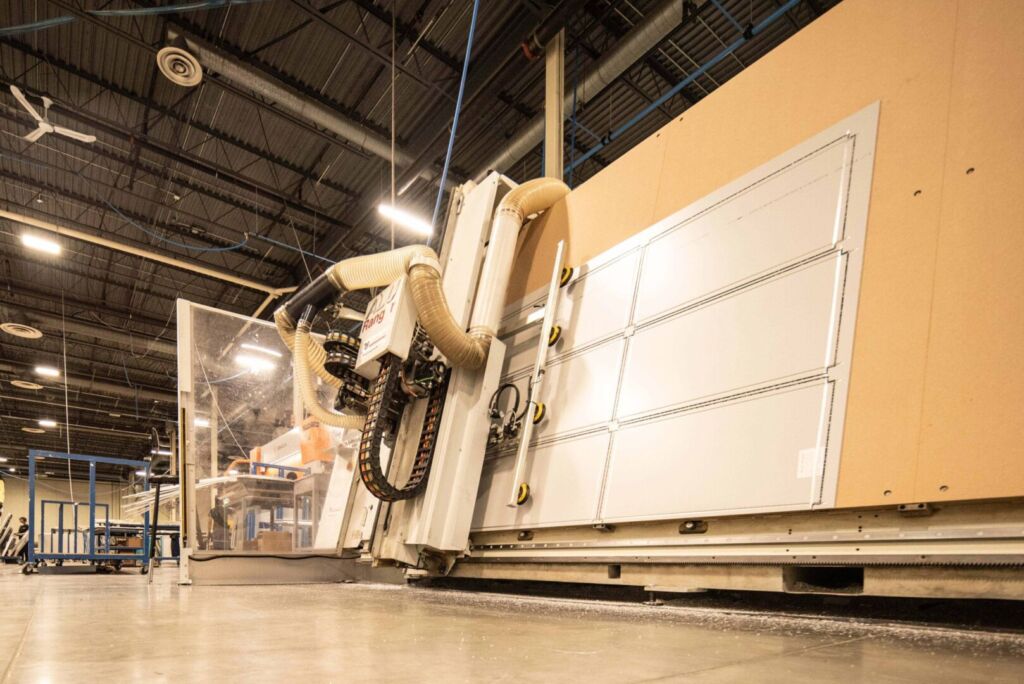 CNC router head carving aluminum panel in industrial shop