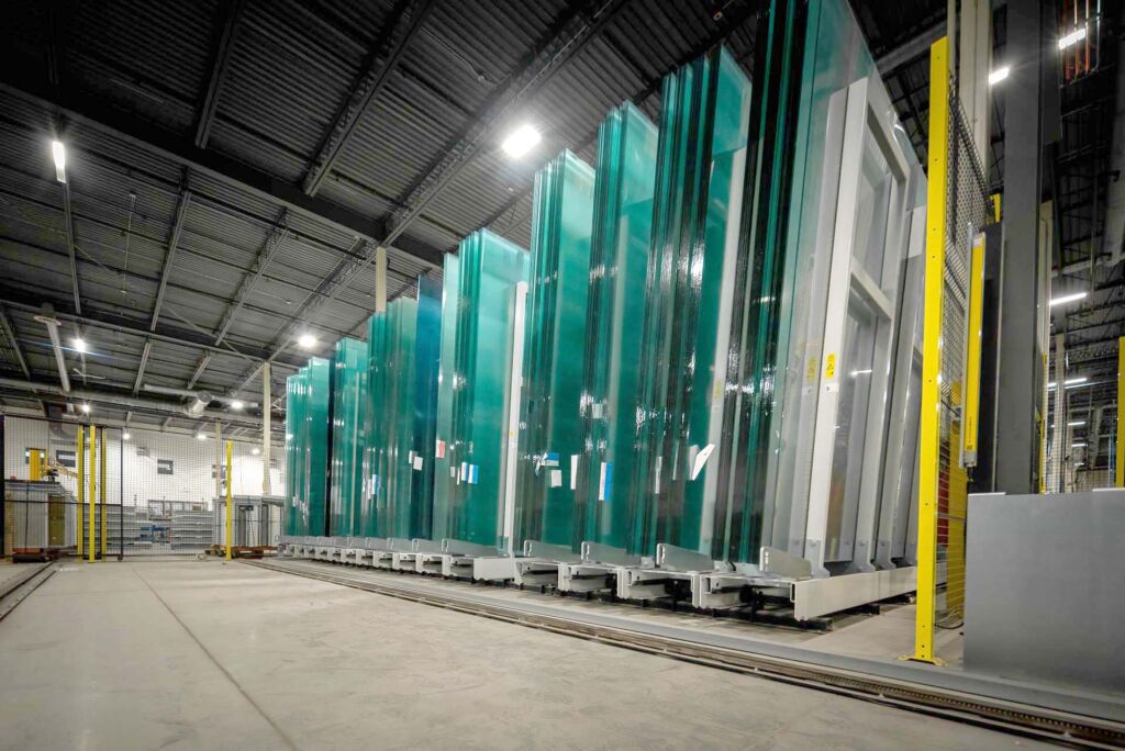 Warehouse row of green architectural glass in storage racks