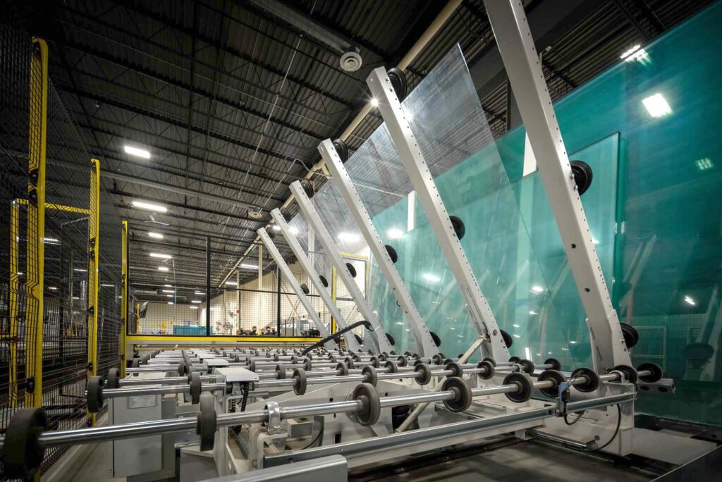 Tall green-tinted glass panels stacked vertically in shop