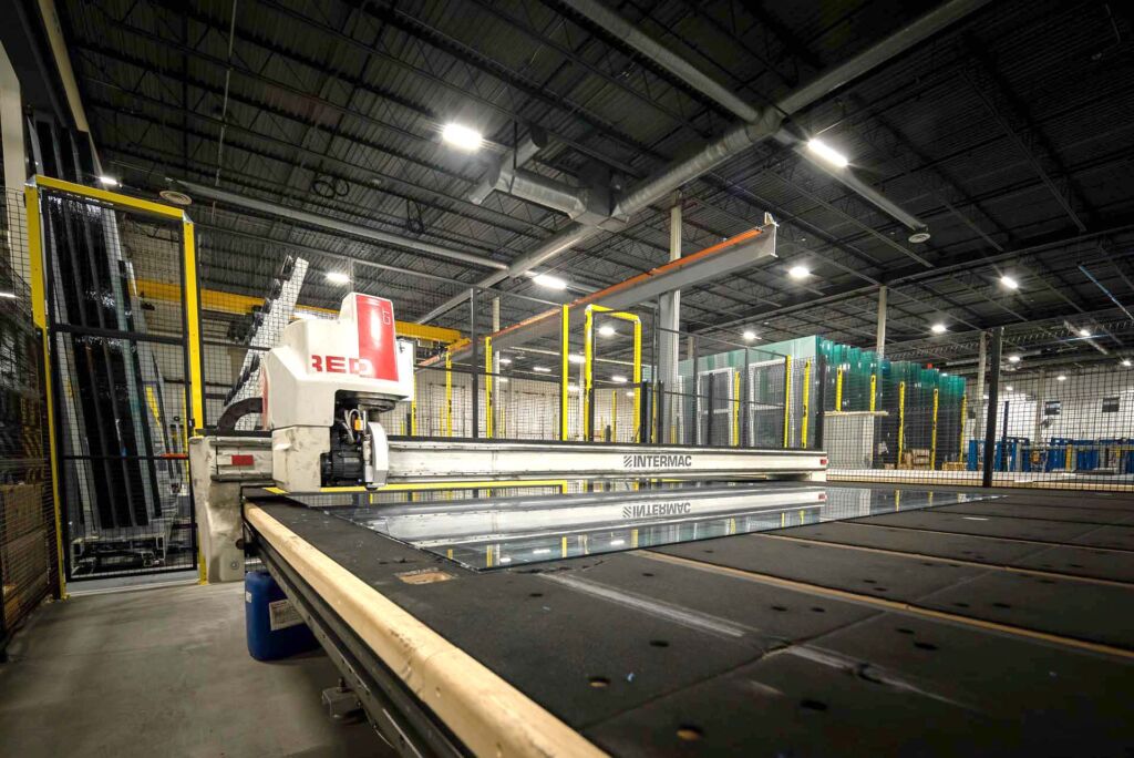 CNC machine calibrating sheet material for glass cutting