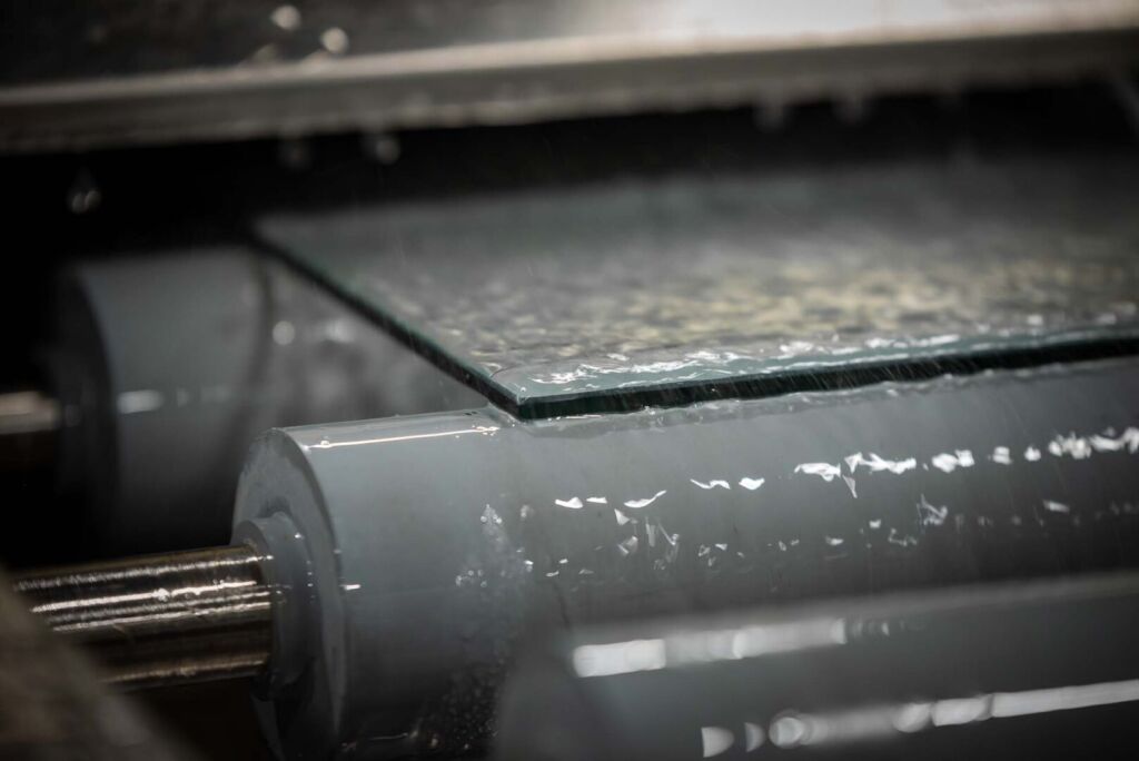 Close-up of water jets cutting or cleaning glass surface