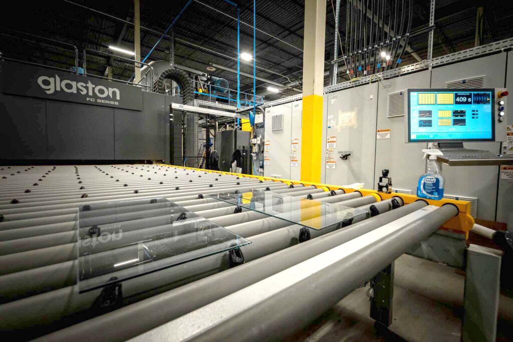 Glass panel exiting oven on roller conveyor system