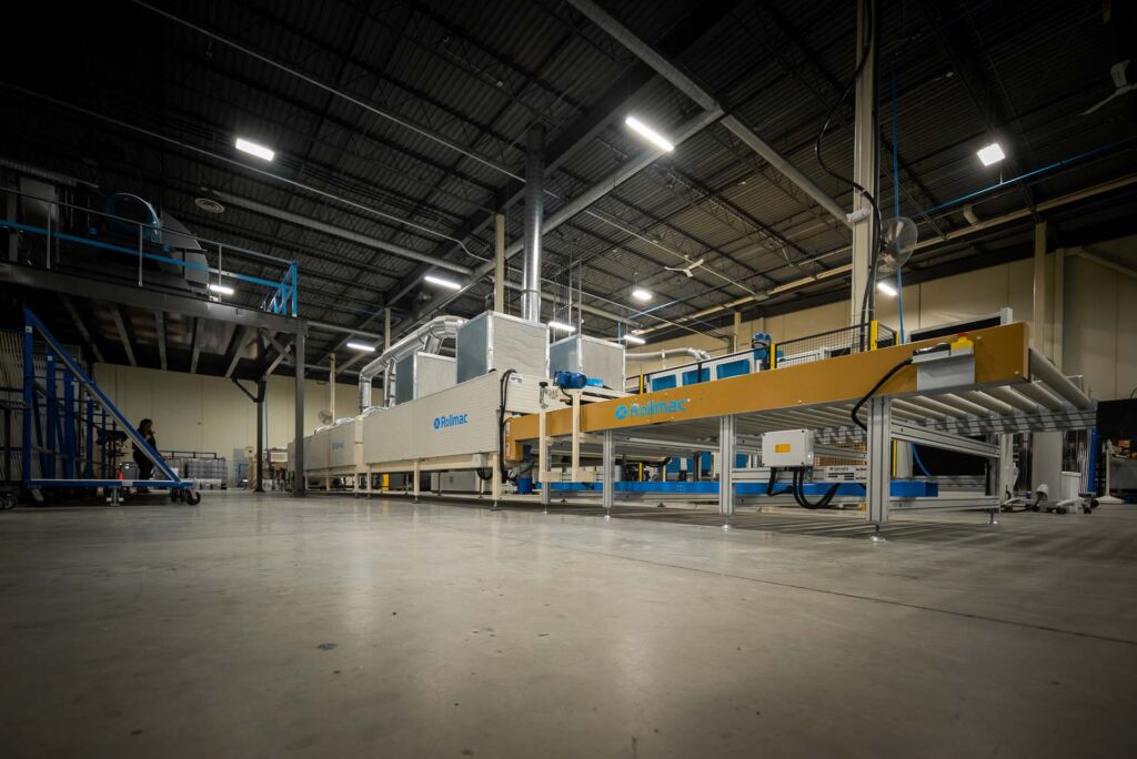 Large industrial glass furnace in modern factory space