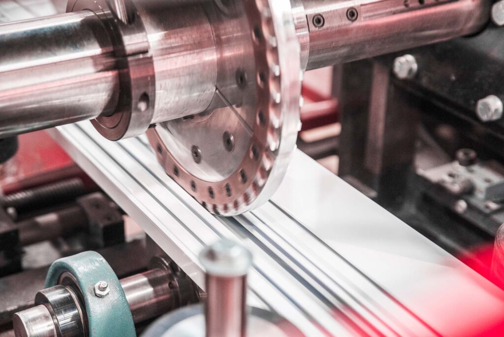 Circular saw blade cutting aluminum profile in factory setting