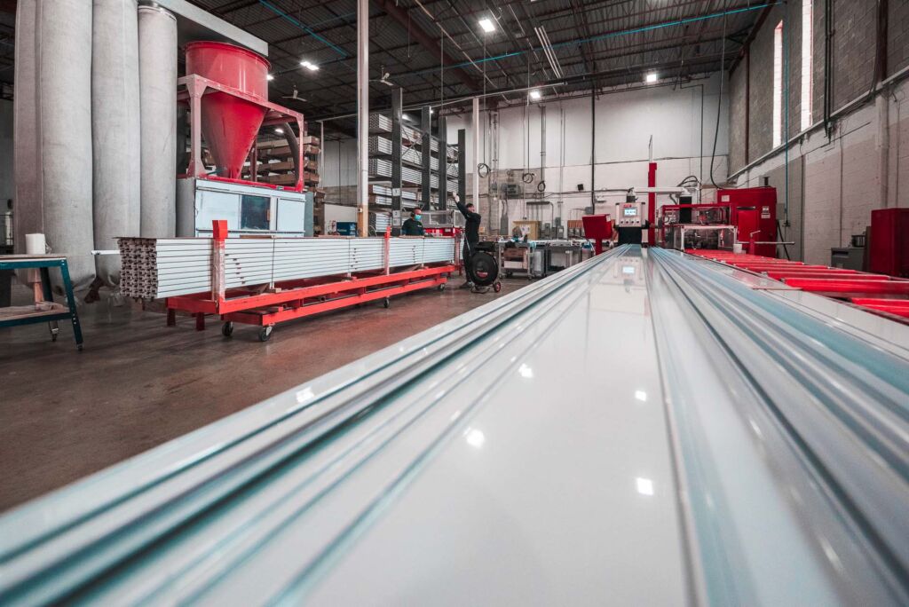 Long aluminum profiles neatly stacked in warehouse aisle
