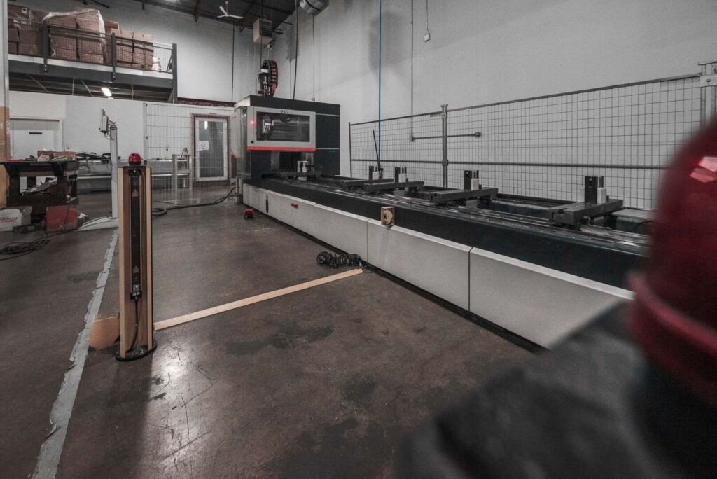 Wide shot of aluminum fabrication facility with extrusion tables